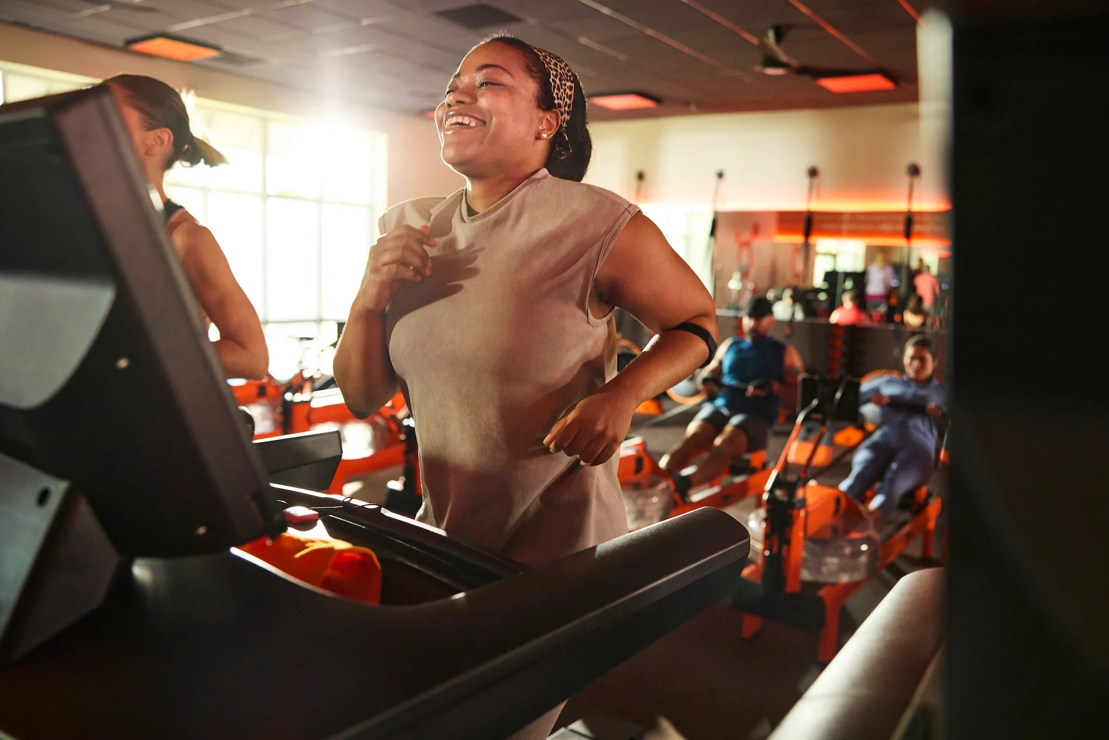 Orangetheory Fitness members rowing and performing strength exercises in a high-energy group workout