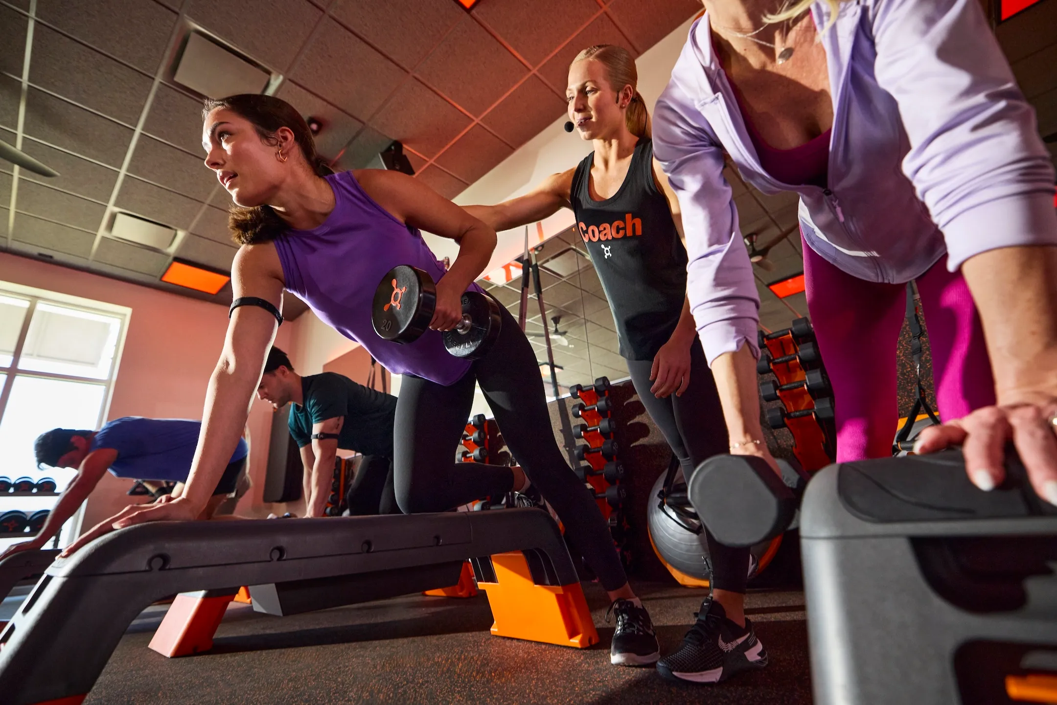 Orangetheory Fitness members walking and running on treadmills during a workout